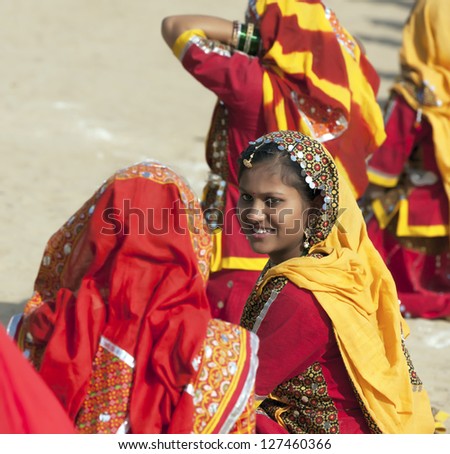 PUSHKAR, INDIA - NOVEMBER 21: An unidentified group girls in colorful ethnic attire attends at the Pushkar fair on November 21, 2012 in Pushkar, Rajasthan, India.