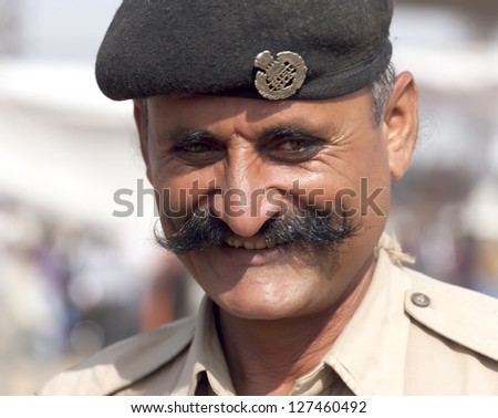 PUSHKAR, INDIA - NOVEMBER 21: Portrait of a unidentified police officer on the Pushkar fair on November 21, 2012 in Pushkar, Rajasthan, India.