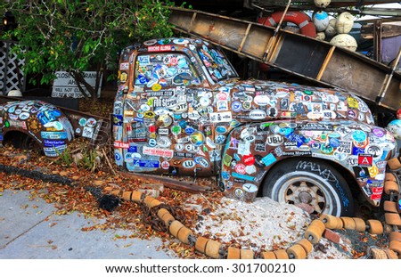 KEY WEST, FLORIDA, USA - 08 October, 2014: Old car covered with a variety of stickers at Bo\'s Fish Wagon restaurant in Key West, Florida, USA on 08 October, 2014.