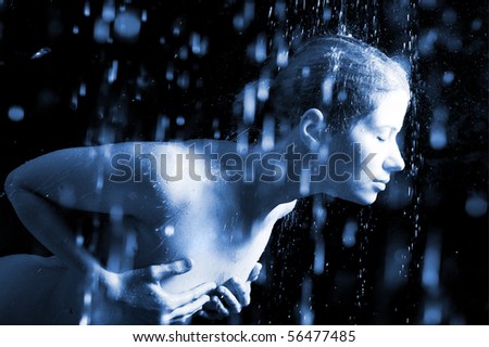 The young sexual woman in splashes of water. Flying drops. Water studio photo.