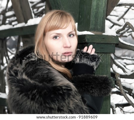 Beautiful young woman in winter fur coat. Winter portrait. Arkhangelskoe Park. Moscow region.