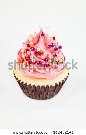 A pink cupcake ornament against a white background