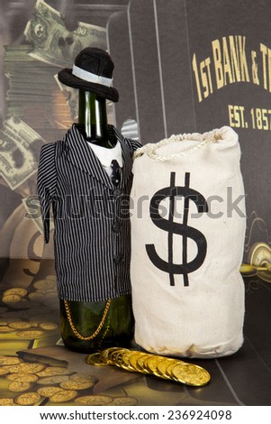 A wine bottle dressed in a zoot suit, next to money pouch