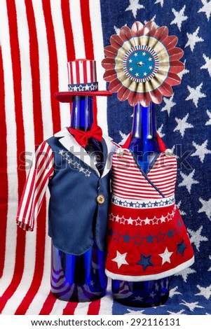 A pair of wine bottles dressed up for the Fourth of July