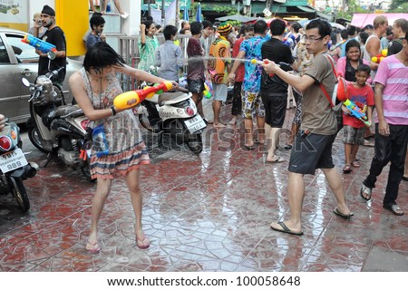 BANGKOK - APRIL 13: Unidentified revellers participate in a water fight in celebrating the Thai new year on April 13, 2012 in Bangkok, Thailand. The new year celebrations are held from 13 to 15 April.