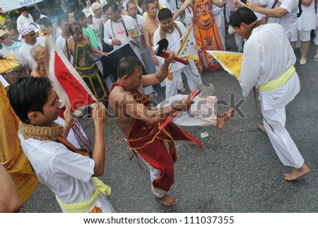 PHUKET - OCT 4: Taoist devotees perform a spirit dance at the Nine Emporer Gods Festival, known locally as the Phuket Vegetarian Festival on Oct 4, 2011 in Phuket, Thailand.