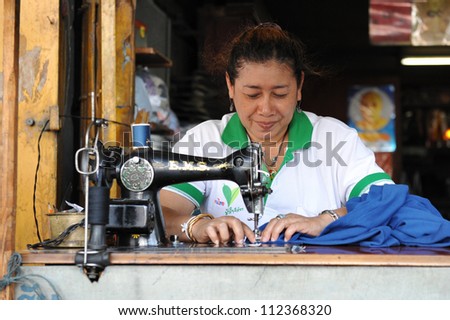 BANGKOK - JAN 11: An unidentified woman operates a sewing machine in a garments factory on Jan 11, 2011 in Bangkok, Thailand. Textile and clothing is Thailand\'s largest manufacturing industry.
