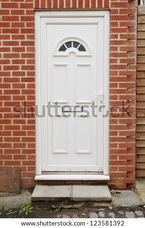 White Front Door of a Red Brick English Town House