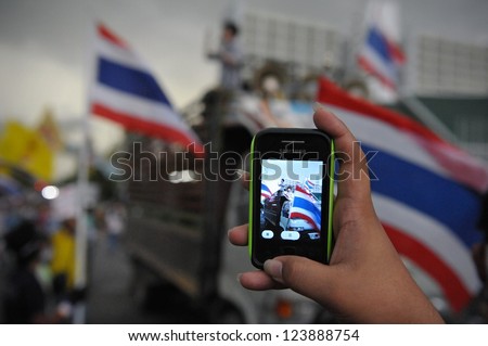 Bangkok - Nov 24: A Protesters Uses A Smartphone To Video An Anti-Government Pitak Siam Rally At Makhawan Bridge On Nov 24, 2012 In Bangkok, Thailand.