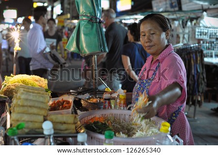 BANGKOK - AUG 23: An unidentified street vendor cooks at a night market on Aug 23, 2012 in Bangkok, Thailand. According gov stats there are over 16,000 registered street vendors in Bangkok.
