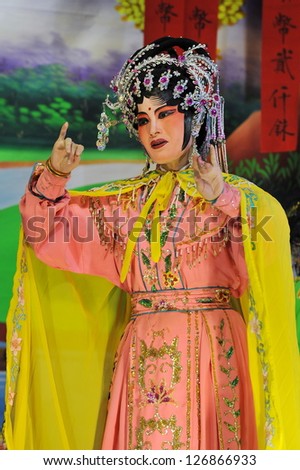 BANGKOK - JAN 14: An unidentifed actress appears in a public showing of Chinese street opera in Banglampu district on Jan 14, 2013. Chinese opera originated in the Tang dynasty cira 720 AD.