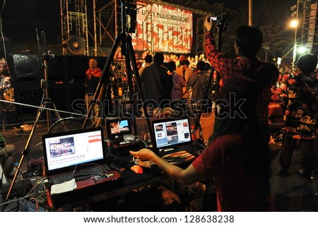 BANGKOK - JAN 29: An unidentified video editor operates an editing system during a large red-shirt rally on the Royal Plaza on Jan 29, 2013 in Bangkok, Thailand.