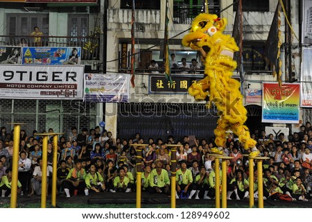 YANGON - FEB 11: A dance troupe perfom a tradition lion dance on a downtown street during celebrations ushering in the Chinese new year of the snake on Feb 11, 2013 in Yangon, Burma.