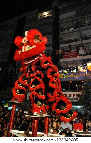 YANGON - FEB 10: A dance troupe perfom a tradition lion dance on a downtown street during celebrations ushering in the Chinese new year of the snake on Feb 10, 2013 in Yangon, Burma.