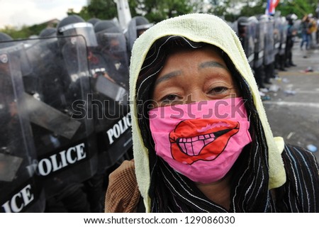 BANGKOK - NOV 24: A protester from the nationalist Pitak Siam confronts riot police during a violent anti-government rally on Nov 24, 2012 in Bangkok, Thailand.