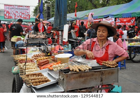 BANGKOK - JAN 29: An unidentified street vendor prepares food at a red-shirt rally on Jan 29, 2013 in Bangkok, Thailand. According gov stats there are over 16,000 registered street vendors in Bangkok.