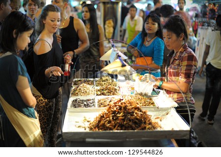 Bangkok - Aug 23: A Street Vendor Sells Fried Insects To Tourists On Khao San Road On Aug 23, 2012 In Bangkok, Thailand. According Gov Stats There Are Over 16,000 Registered Street Vendors In Bangkok.