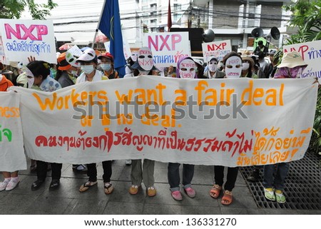 BANGKOK - MARCH 13: Thai NXP workers protest infront of the Royal Netherlands Embassy on March 13, 2013 in Bangkok, Thailand. Union workers gathered to request better wages and work conditions.