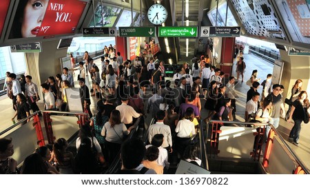 BANGKOK - FEB 6: Travelers crowd Siam Square BTS (Bangkok Transit System) Station during rush hour on Feb 6, 2013 in Bangkok, Thailand. Launched in 1999 the BTS currently has 31 stations.