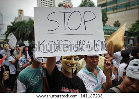 BANGKOK - JUN 2: Anti-government protesters wearing Guy Fawkes masks rally in Bangkok\'s shopping district on Jun 2, 2013 in Bangkok, Thailand. The protesters call for the government to be overthrown.