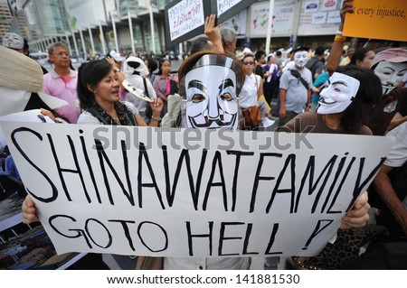 BANGKOK - JUN 9: Anti-government protesters wearing Guy Fawkes masks rally in Bangkok's shopping district on Jun 9, 2013 in Bangkok, Thailand. The protesters call for the government to be overthrown.