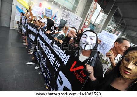 BANGKOK - JUN 9: Anti-government protesters wearing Guy Fawkes masks rally in Bangkok\'s shopping district on Jun 9, 2013 in Bangkok, Thailand. The protesters call for the government to be overthrown.