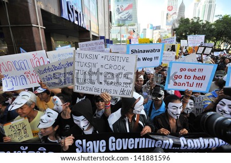 BANGKOK - JUN 9: Anti-government protesters wearing Guy Fawkes masks rally in Bangkok\'s shopping district on Jun 9, 2013 in Bangkok, Thailand. The protesters call for the government to be overthrown.