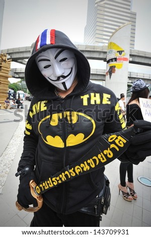 BANGKOK - JUNE 16: A royalist protester wearing a Guy Fawkes mask joins a large anti-government rally in Bangkok\'s shopping district on June 16, 2013 in Bangkok, Thailand.