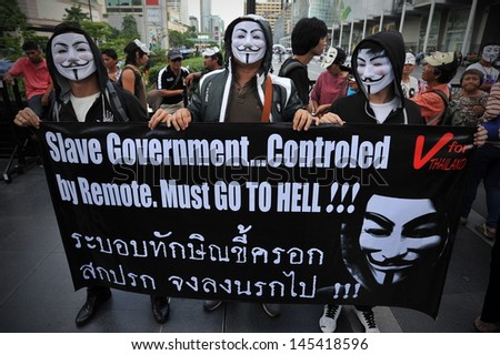 BANGKOK - JUN 9: Anti-government protesters wearing Guy Fawkes masks rally in Bangkok\'s shopping district on Jun 2, 2013 in Bangkok, Thailand. The protesters call for the government to be overthrown.