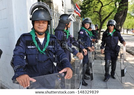 BANGKOK - AUG 1: Police on standby at Government House as the government invokes martial law amid threats to national security and planned anti-government rallies on Aug 1, 2013 in Bangkok, Thailand.