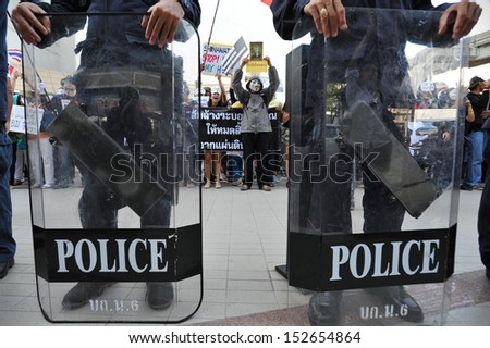 BANGKOK - JUN 9: Riot police standby as anti-government protesters wearing Guy Fawkes masks rally in Bangkok\'s shopping district on Jun 9, 2013 in Bangkok, Thailand.