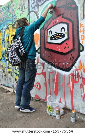 BRISTOL, UK - OCT 22: An unidentified street artist works on a graffiti piece in the Stokes Croft area of the city on Oct 22, 2010 in Bristol, UK. Bristol is well-known for its vibrant street art scene.