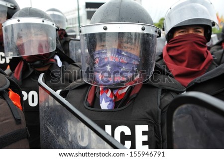 BANGKOK - NOV 24: Riot police stand guard on Makhawan Bridge during a violent anti-government rally on Nov 24, 2012 in Bangkok, Thailand. Protesters and police clashed repeatedly with dozens injured.