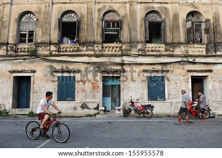 BANGKOK - JUN 3: Unidentified people gather on the street in a community that resides in Bangkok\'s former Customs House on Jun 3, 2013. Many buildings built circa 19th century now lie semi-derelict .