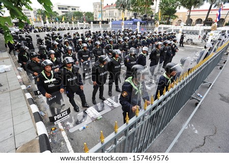 BANGKOK - OCT 8: Twelve companies of riot police officers stand guard outside Government House as anti-government protesters hold a rally in the vicinity on Oct 8, 2013 in Bangkok, Thailand.