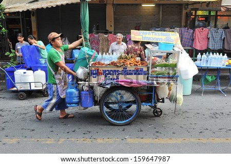 Bangkok - Apr 12: An Unidentified Vendor Pushes A Mobile Kitchen On A Street In The Khao San Area On Apr 12, 2013 In Bangkok, Thailand. There Are 16000 Registered Street Vendors In The Thai Capital.