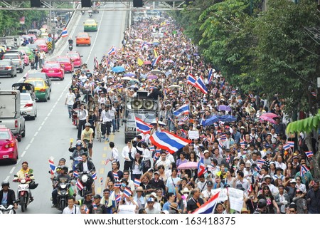 BANGKOK - NOV 11: Protesters march through the Thai capital to join a large anti-government rally on Nov 11, 2013 in Bangkok, Thailand. The protesters call for the government to be overthrown.