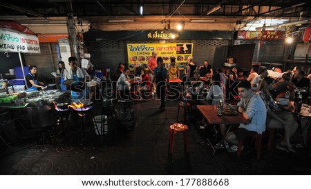 BANGKOK - DEC 18: Unidentified diners eat at a busy street side restaurant in Chinatown on Dec 18, 2013 in Bangkok, Thailand. Bangkok\'s Chinatown is renowned for its street food and outdoor dining.