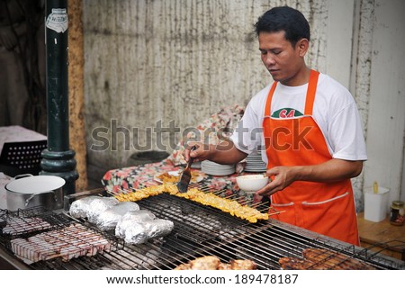 BANGKOK - AUG 23: A street vendor prepares food in the Khao San Road area on Aug 23, 2012 in Bangkok, Thailand. There are 16,000 registered street vendors in Bangkok according to the government.