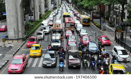BANGKOK - MAY 31: Traffic waits at a busy junction in the city centre on May 31, 2013 in Bangkok, Thailand. Annually an estimated 150,000 new cars join the heavily congested roads of Bangkok.