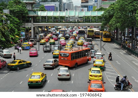 BANGKOK - MAY 31: Traffic makes its way along a busy road in the city centre on May 31, 2013 in Bangkok, Thailand. Annually an estimated 150,000 new cars join the heavily congested roads of Bangkok.