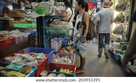BANGKOK - SEP 11: Tourists and locals shop at Chatuchak Weekend Market Sep 11, 2011 in Bangkok, Thailand. The Thai capital's Chatuchak is the world's largest outdoor street markets with 15,000 stalls.