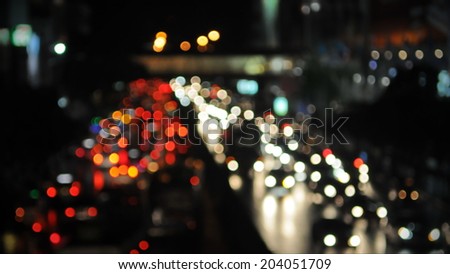 Defocused Lights of Traffic on a Busy City Road at Night