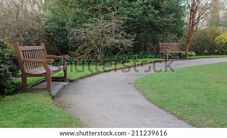 Wooden Benches and Pathway in a Park in Spring - Namely Victoria Park in Bath England