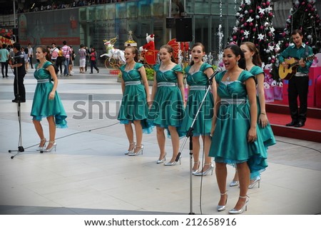 BANGKOK - DEC 23: Unidentified choir singers perform Christmas carols at Siam Paragon mall courtyard on Dec 23, 2011 in Bangkok, Thailand. Siam Paragon boasts 300,000 square metres of retail space.
