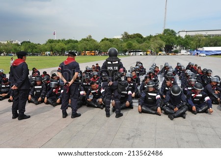 BANGKOK - JUL 11: Police officers in riot gear sit for debriefing after protests over a cabinet reshuffle with PM Yingluck Shinawatra doubling as Defence Minister on Jul 11, 2013 in Bangkok, Thailand.