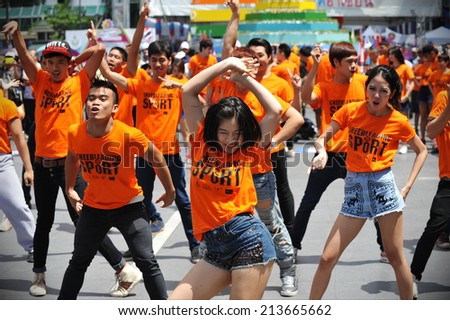 BANGKOK - JUNE 30: A cheerleading flash mob dance troupe perform on a city centre street on June 30, 2013 in Bangkok, Thailand. Cheerleading dance teams are growing in popularity in the Thai capital.