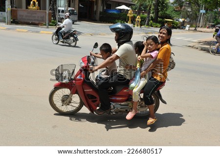SIEM REAP - JUL 11: A family travels by motorbike on Jul 11, 2012 in Siem Reap, Cambodia. Motorbikes are often used as farmily transport in poverty stricken Cambodia, where over 20% live on $1 a day.