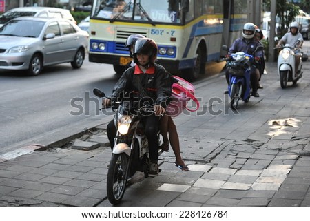 BANGKOK - JAN 10: Unidentified motorcyclists ride on a pavement during rush hour on Jan 10, 2013 in Bangkok, Thailand. Road traffic laws are often poorly enforced and overlooked in Thailand.