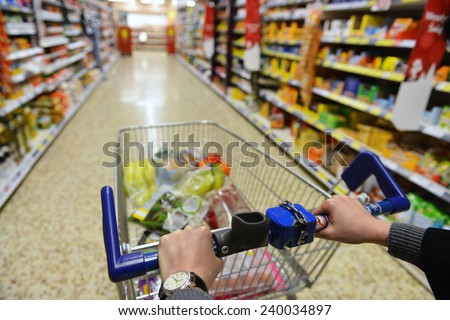 Shopping Cart View on a Supermarket Aisle and Shelves - Image Has a Shallow Depth of Field